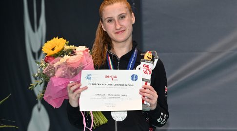 Carolina Stutchbury smiles with a certificate and flowers