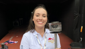 Olivia smiling at camera holding an Olympic Torch