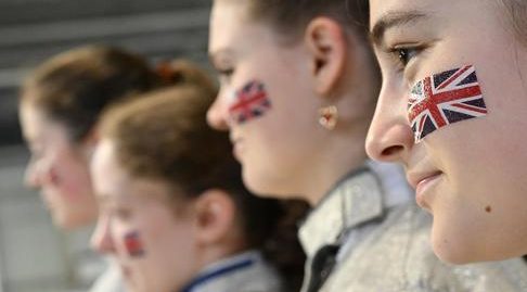Side profile photo of four fencers with the GBR flag on their face.