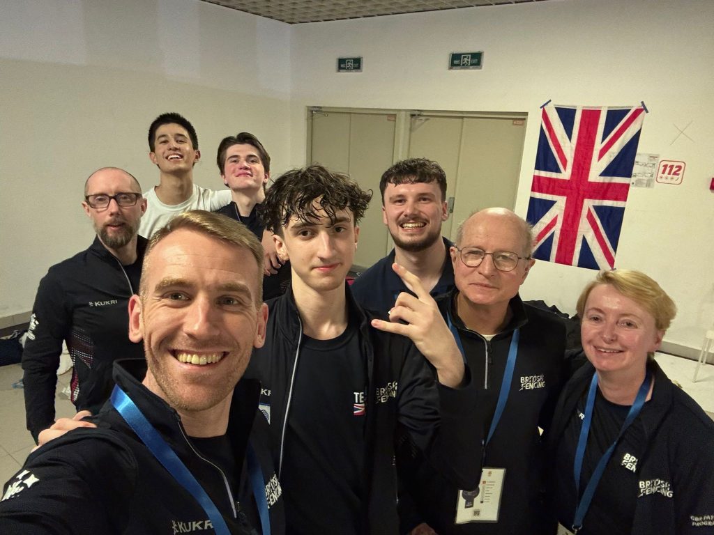 A group of GBR fencers and coaches take a selfie.