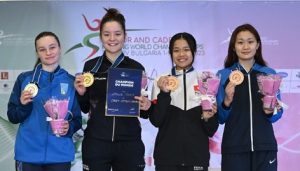 fencers on the podium with Amelie Tsang holding her gold medal and certificate