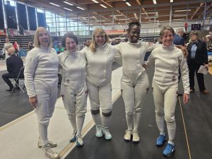 Womens epee team smiling at camera