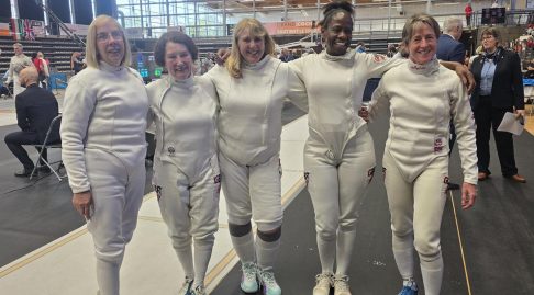 Womens epee team smiling at camera