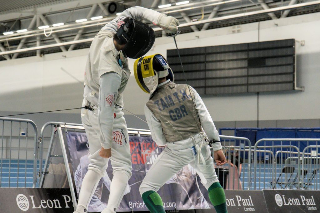 Two U14 foil fencers in action