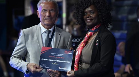 Pat Aiyenuro presents SwordSeat family certificate to the President of the German Fencing Federation