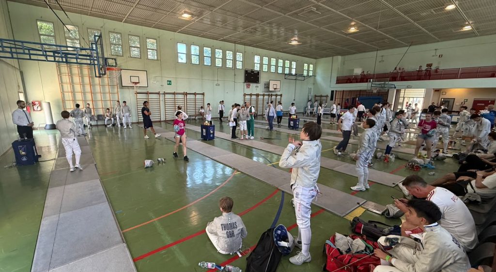 A sports hall where a fencing competition is taking place